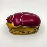 Close-up of the hand-painted scarab beetle design on the jewelry box lid