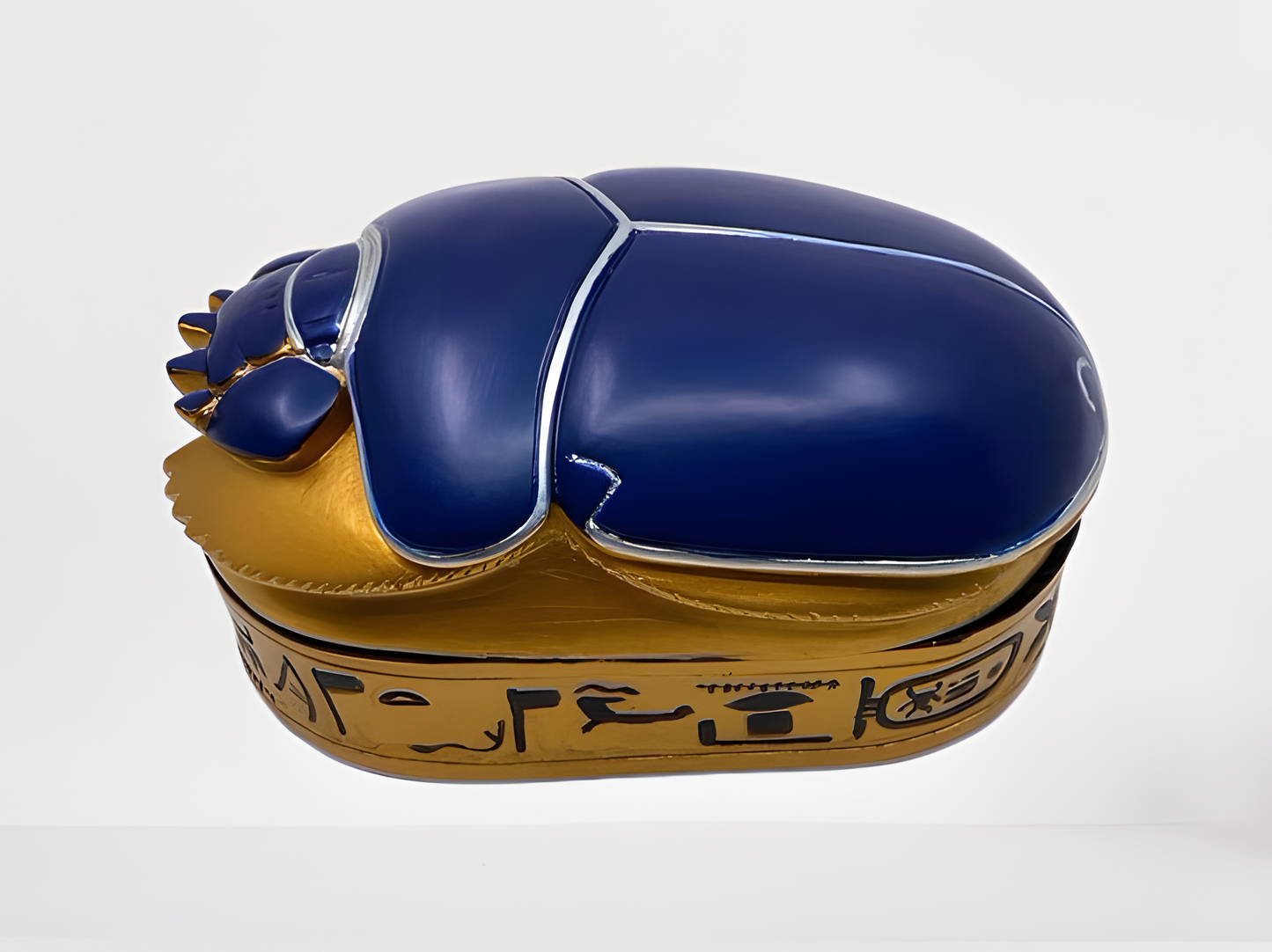Egyptian scarab jewelry box displayed with lid closed, showing full golden oval shape