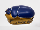Egyptian scarab jewelry box displayed with lid closed, showing full golden oval shape