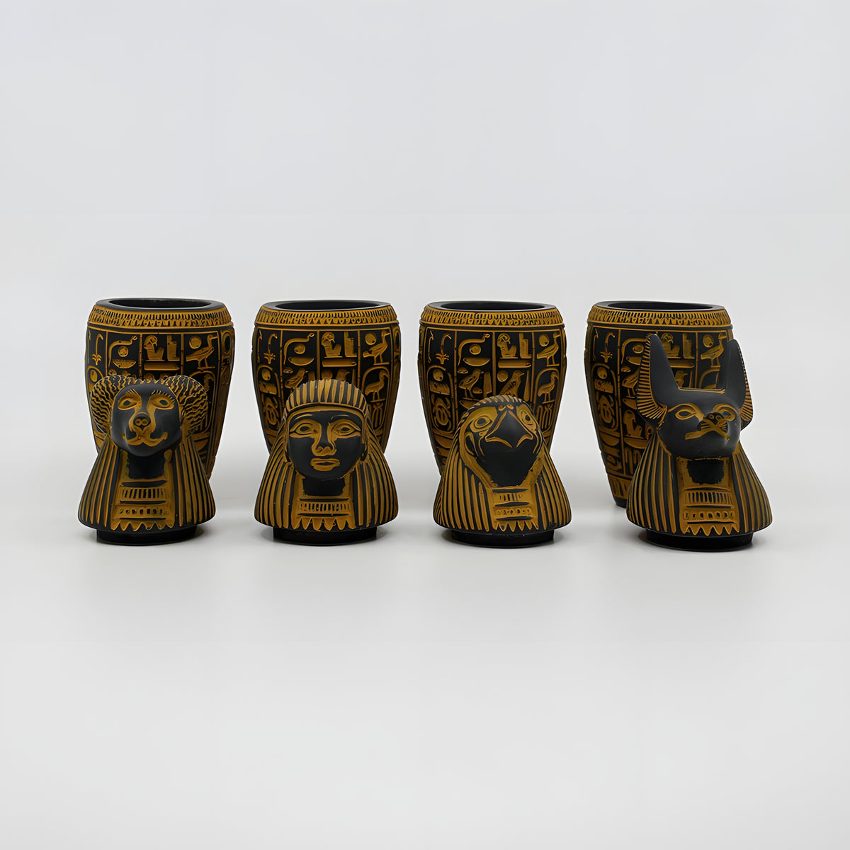 Egyptian canopic jars set, museum reproduction — detail of Imsety and Hapy jar lids