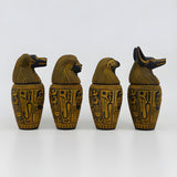 Egyptian canopic jars set, museum reproduction — detail of Duamutef and Qebehsenuef jar lids