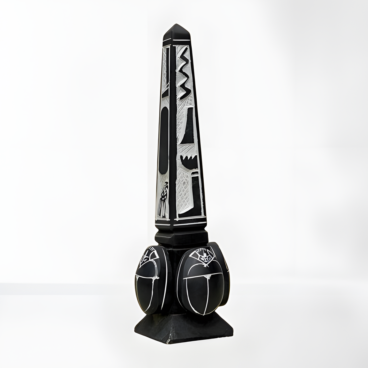 Black stone Egyptian obelisk museum reproduction with hand-carved hieroglyph and scarab motifs