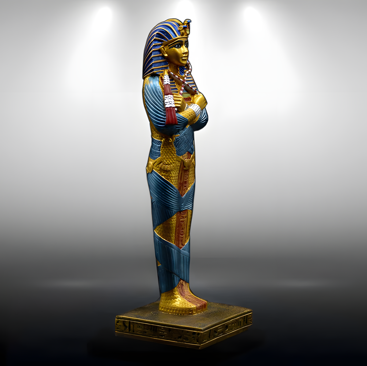 Side view of the hand-painted King Tutankhamun statue, museum reproduction