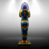 Close-up detail of the King Tutankhamun statue's painted features, museum reproduction