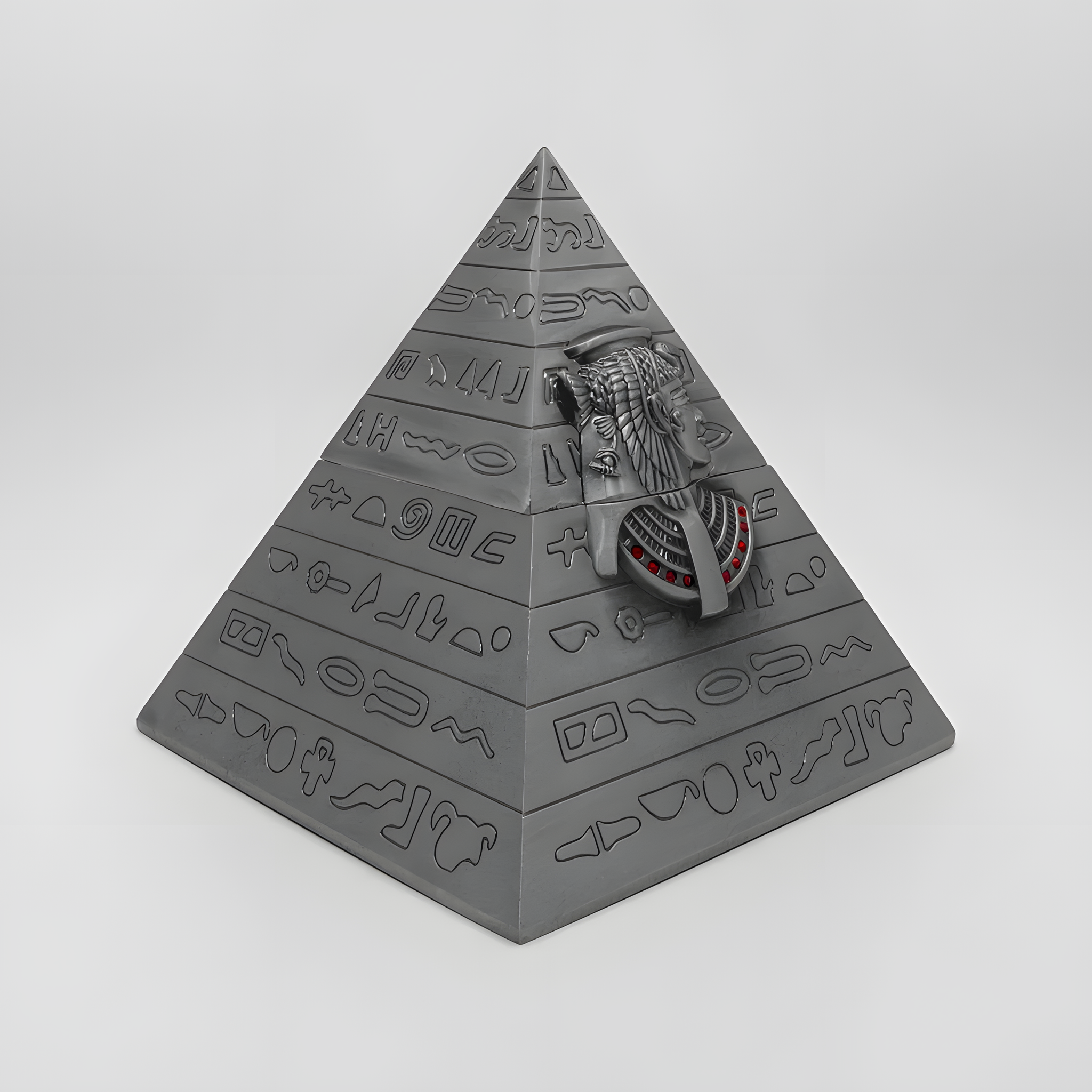 Close-up of the engraved hieroglyphic-style pattern on the pyramid jewelry box