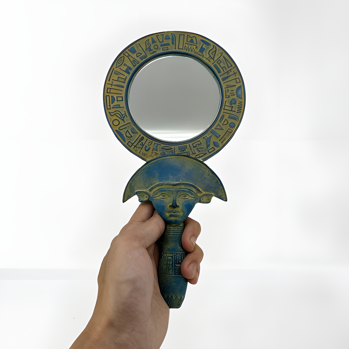 Egyptian Hathor mirror, museum reproduction — detail of carved Hathor-face handle