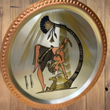 Copper decorative plate depicting a dance scene, hand-engraved wall art, close-up detail