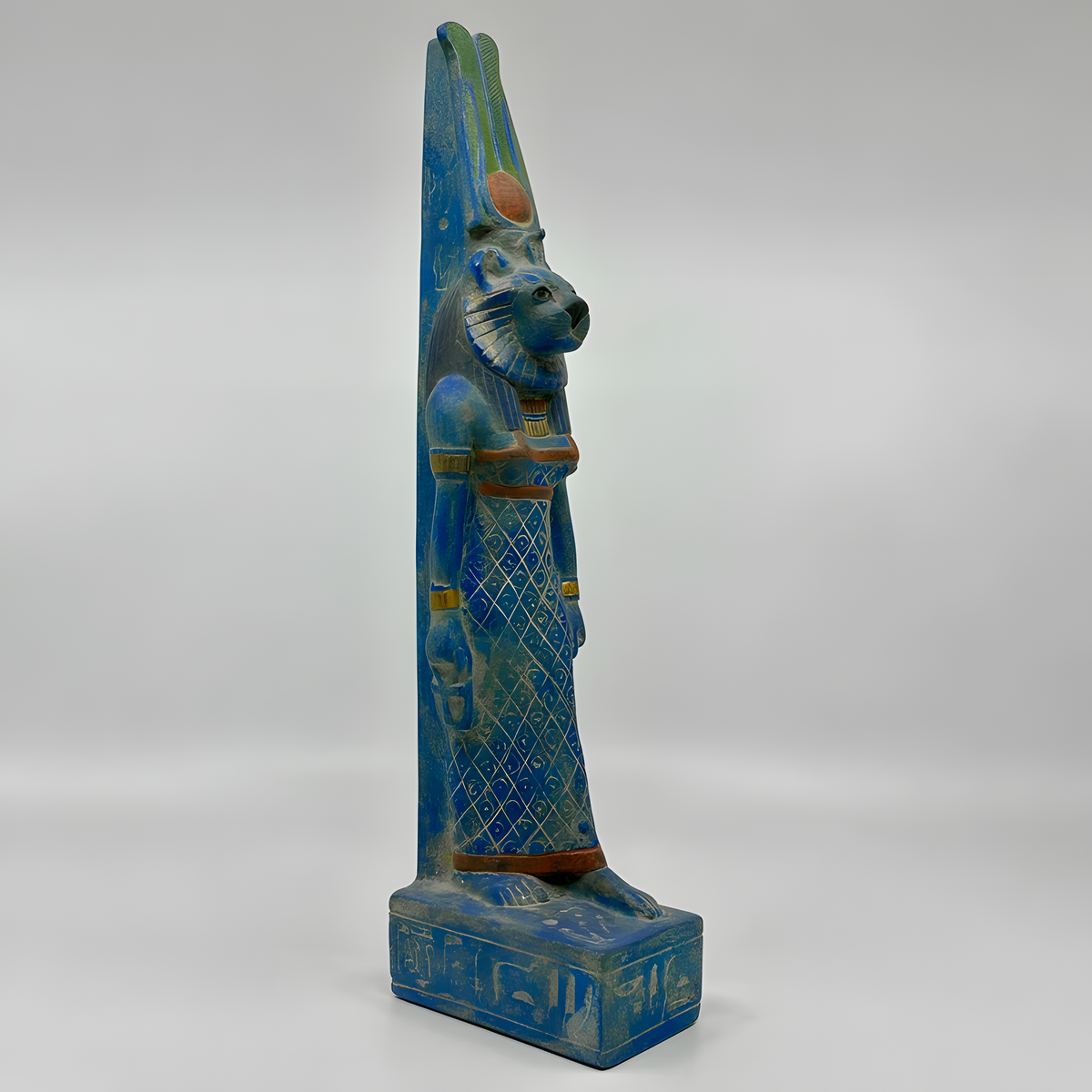 Sekhmet statue in blue stone, museum reproduction, side profile view
