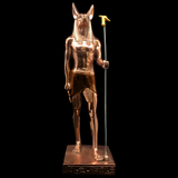 Full-length view of the copper Anubis statue on its base, museum reproduction