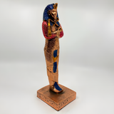 Close-up of the copper Tutankhamun coffin statue museum reproduction showing golden accent detail