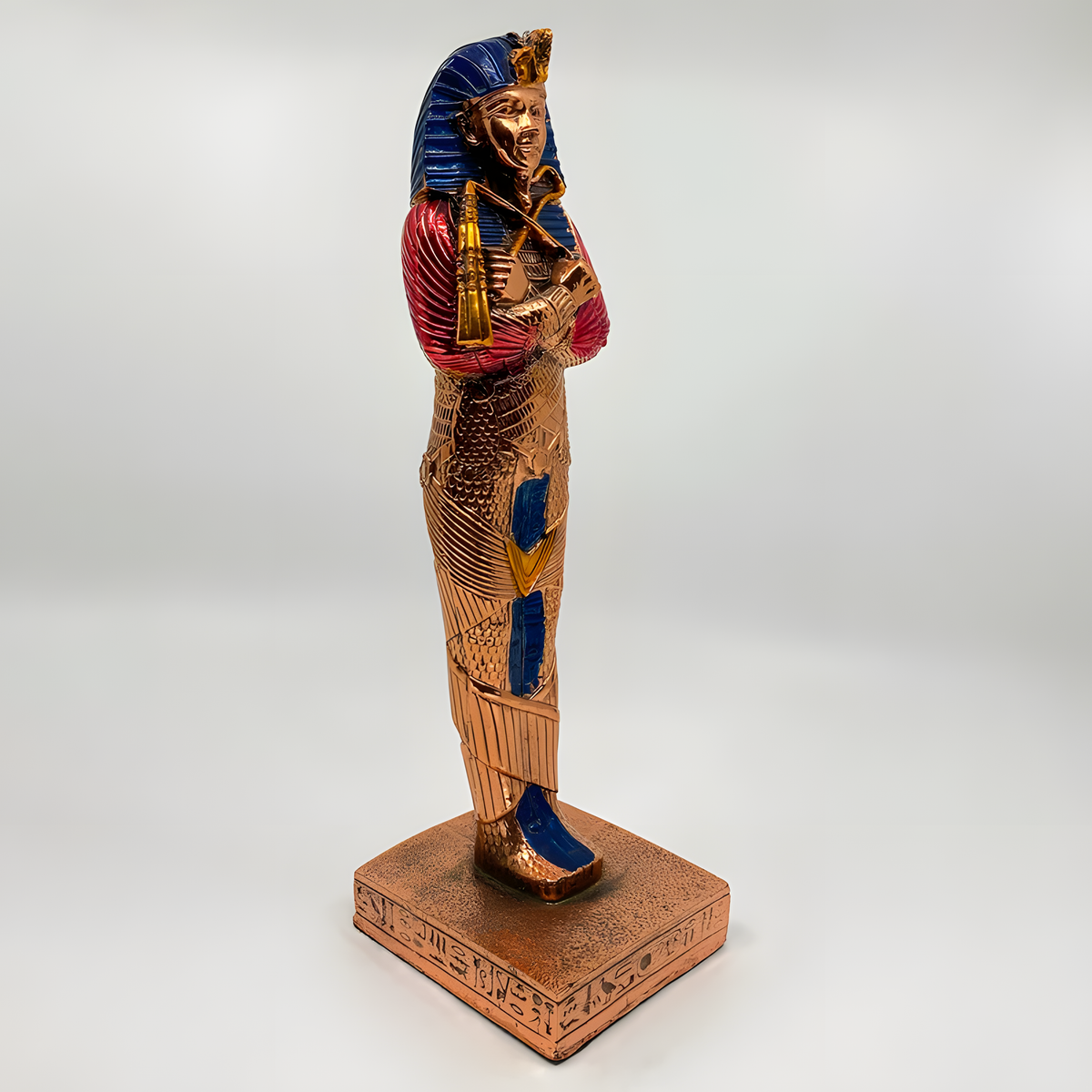Close-up of the copper Tutankhamun coffin statue museum reproduction showing golden accent detail