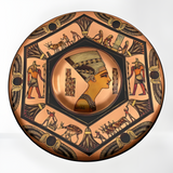 Handmade Egyptian copper wall plate featuring Queen Nefertiti and Anubis relief, angled view