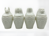Alabaster canopic jars set, museum reproduction — full set of four jars, front view