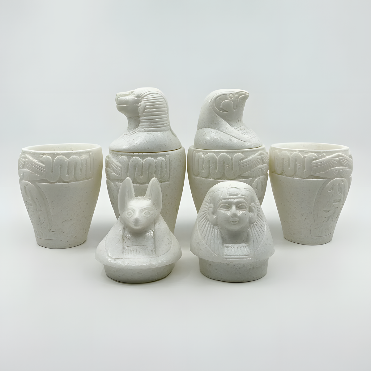 Alabaster canopic jars set, museum reproduction — detail of Imsety and Hapy jar lids