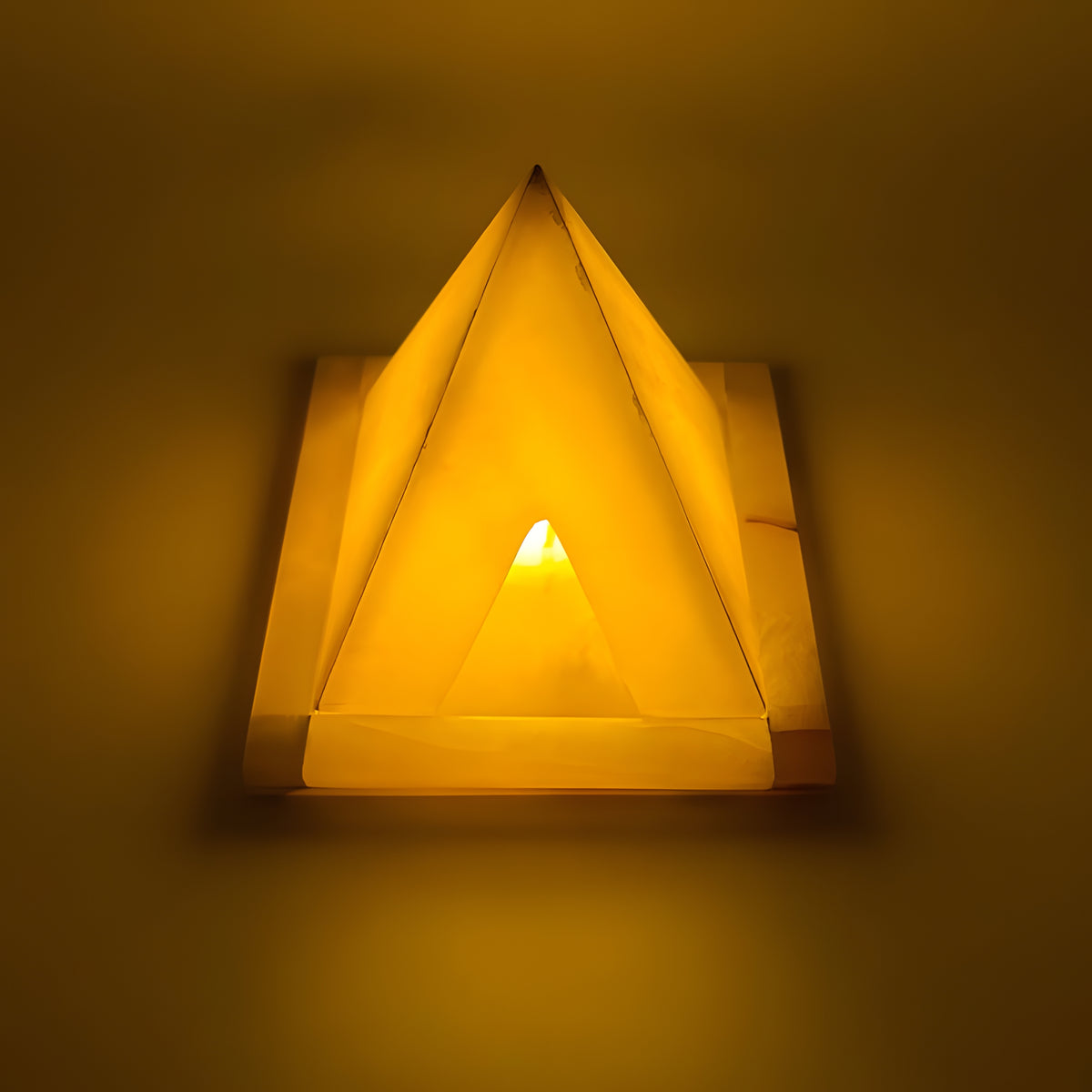 Alabaster pyramid candle holder museum reproduction, angled view showing stone grain