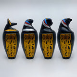 Polystone canopic jar set, museum reproduction — side view showing jar proportions