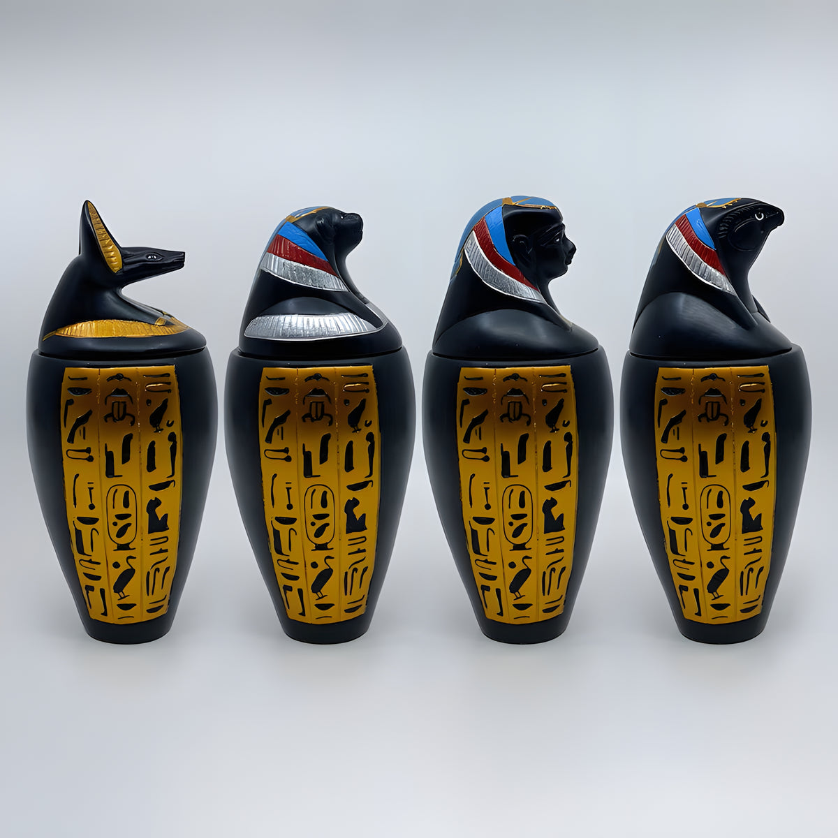 Polystone canopic jar set, museum reproduction — side view showing jar proportions