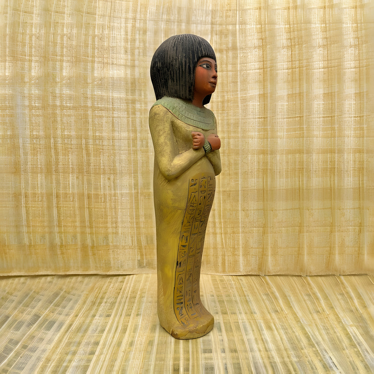 Egyptian Isis goddess statue, museum reproduction — angled view showing carved detail