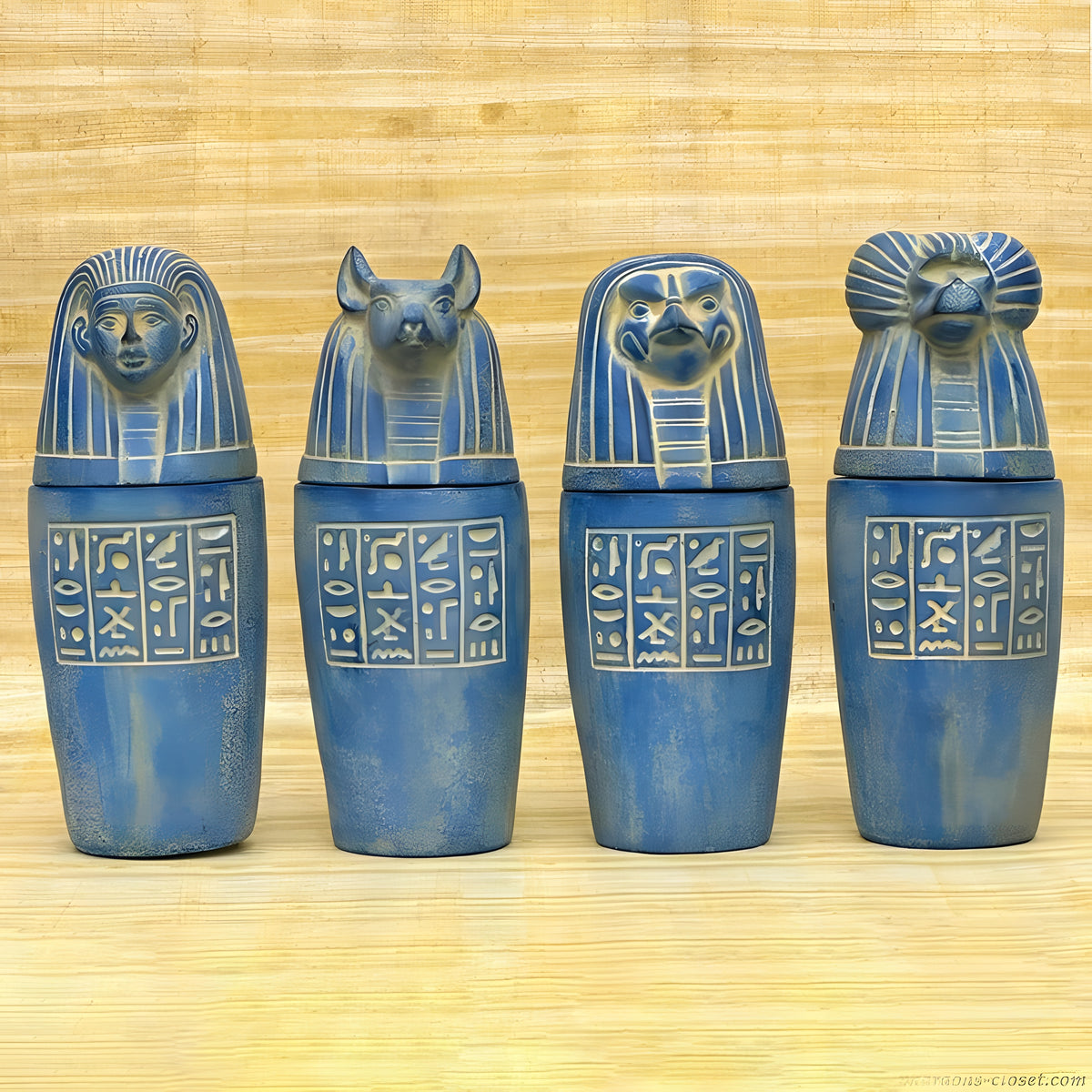 Handcrafted blue stone canopic jar set, museum reproduction — full set of four jars, front view