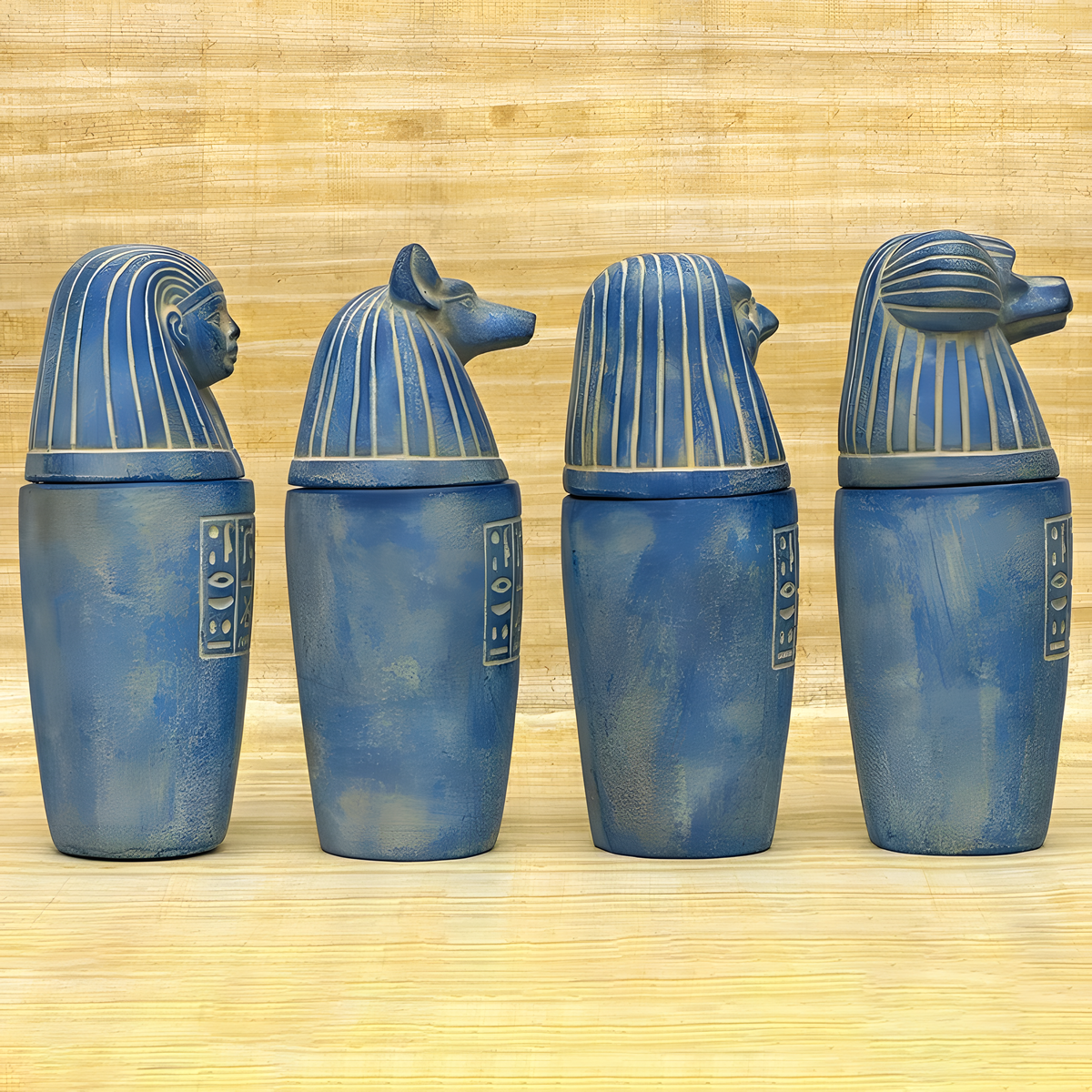 Blue stone canopic jar set, museum reproduction — detail of Imsety and Hapy jar lids
