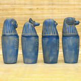 Blue stone canopic jar set, museum reproduction — detail of Imsety and Hapy jar lids