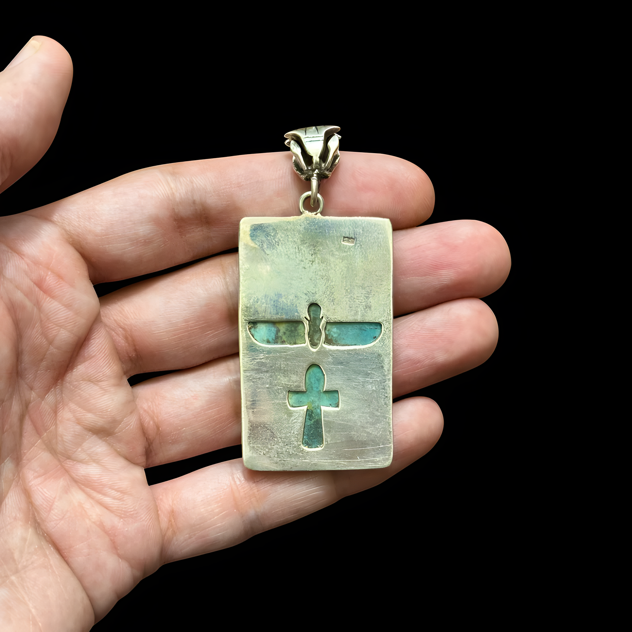 Green hieroglyphic faience-style pendant with silver accents, museum reproduction — detail of hieroglyph motifs