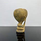 Stone uraeus cobra statue, museum reproduction — close-up of carved detail