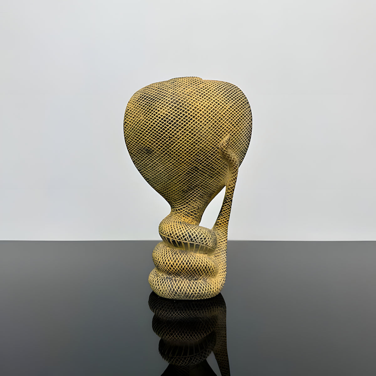 Stone uraeus cobra statue, museum reproduction — close-up of carved detail