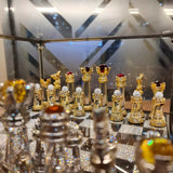 Close-up of gold and chrome plated crystal chess pieces with zircon stone accents