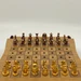 Handmade wooden chess board shown open and set up for play