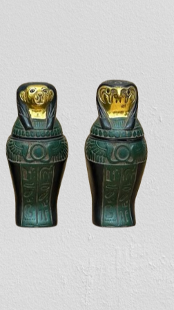 Egyptian winged sun canopic jars set, museum reproduction — detail of jar lid and winged sun disk motif