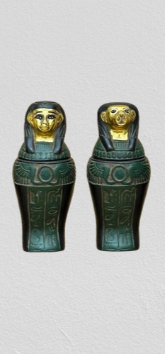Egyptian winged sun canopic jars set, museum reproduction — side view showing carved detail